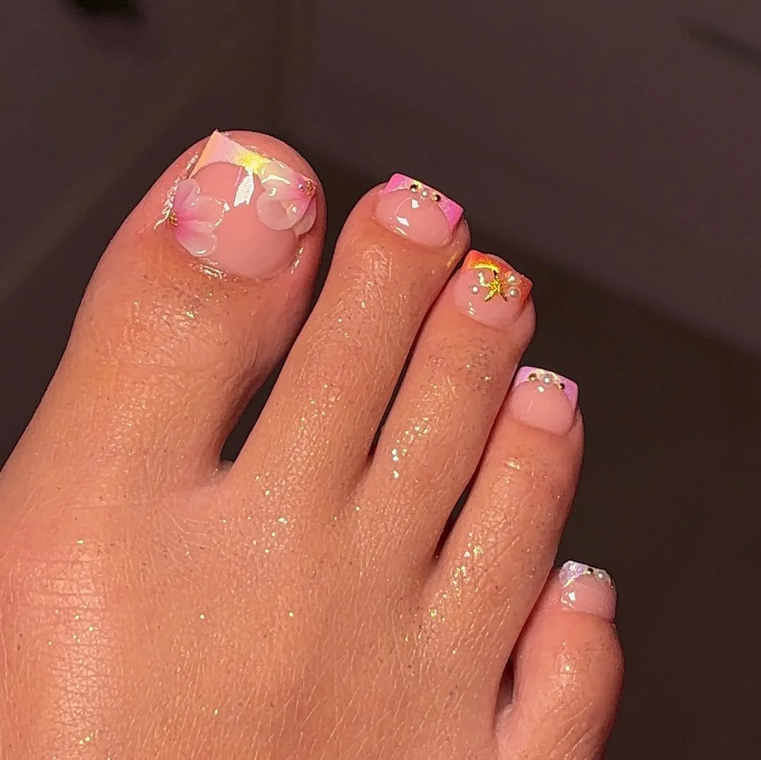 summer toe nails colors 2026 Pink Tips With Gold Foil And Soft Floral Detail
