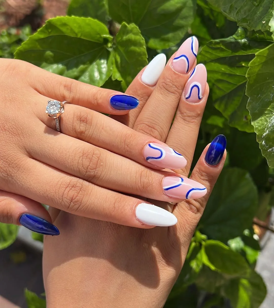 summer vacation nails 2026 White and Cobalt Almond Nails With Wave Lines