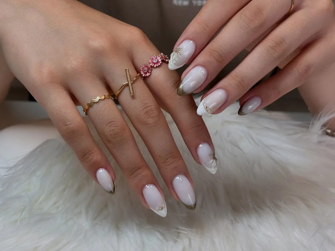 summer vacation nails 2026 Milky White Almond Nails With Soft Gold-Tipped Elegance