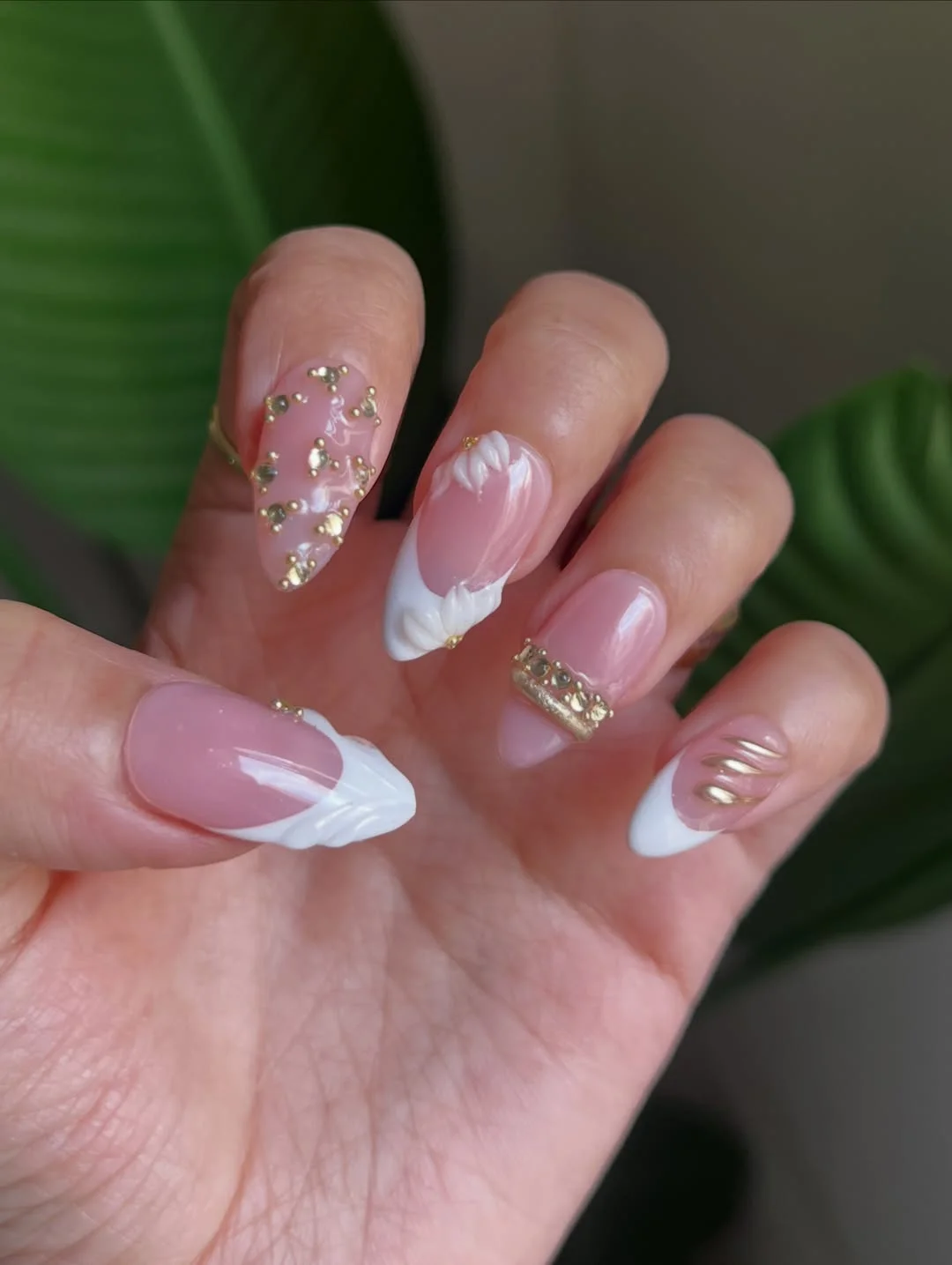 summer vacation nails 2026 Soft Pink Almond Nails With White Petals and Gold Details