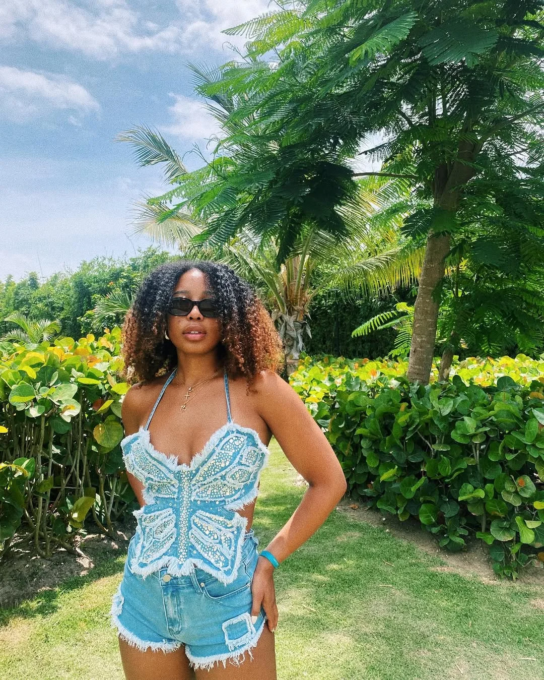25 summer vacation resort outfits 2026 Denim Shorts And A Butterfly Halter For Tropical Day Plans