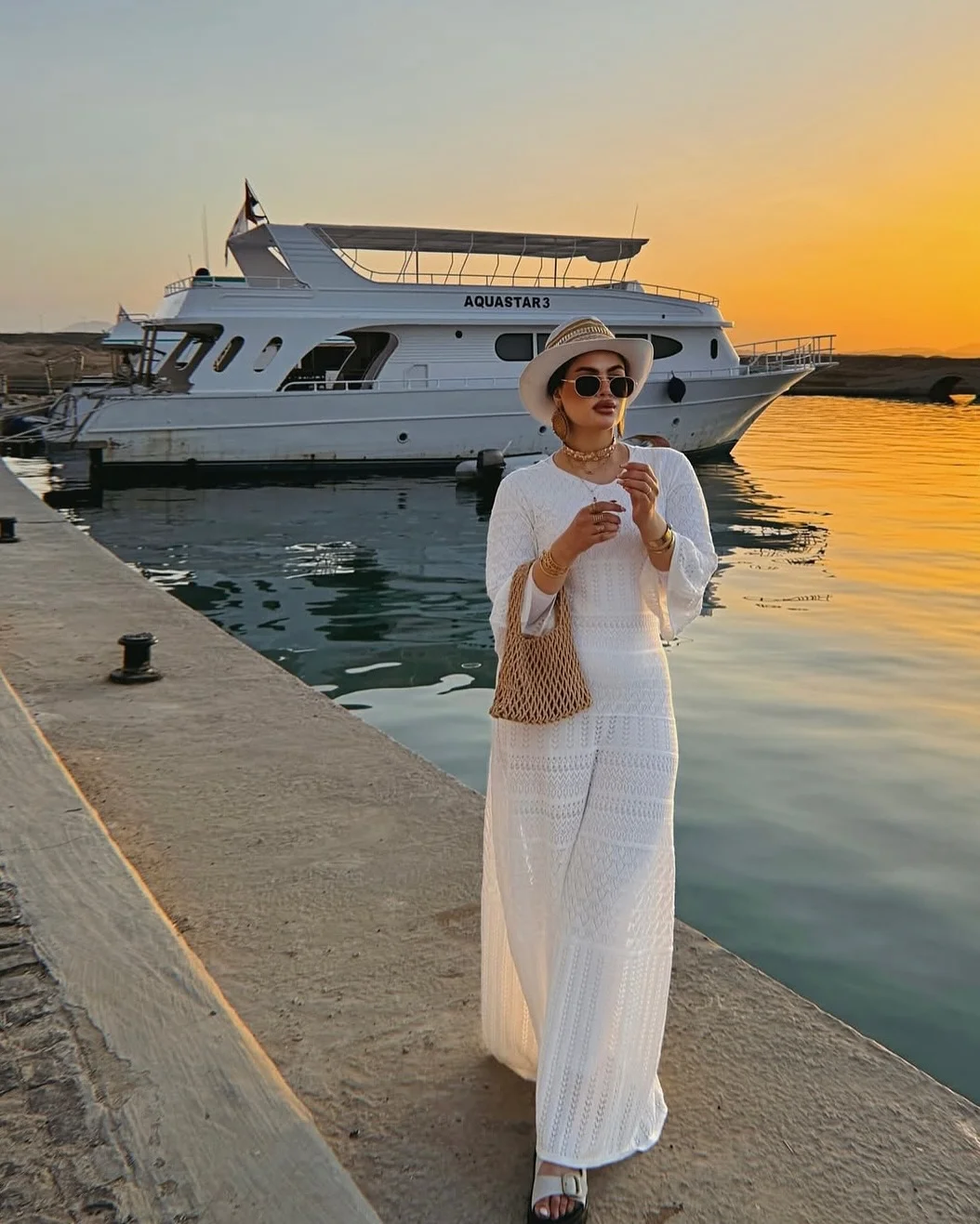 25 summer vacation resort outfits 2026 White Crochet Maxi Dress For Sunset By The Water