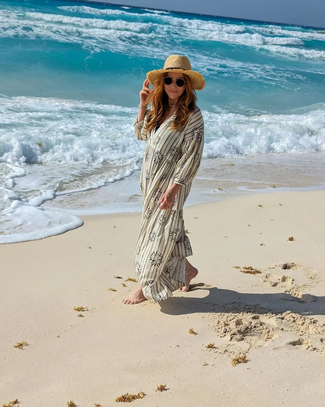 25 summer vacation resort outfits 2026 Striped Beach Maxi Dress With A Straw Hat