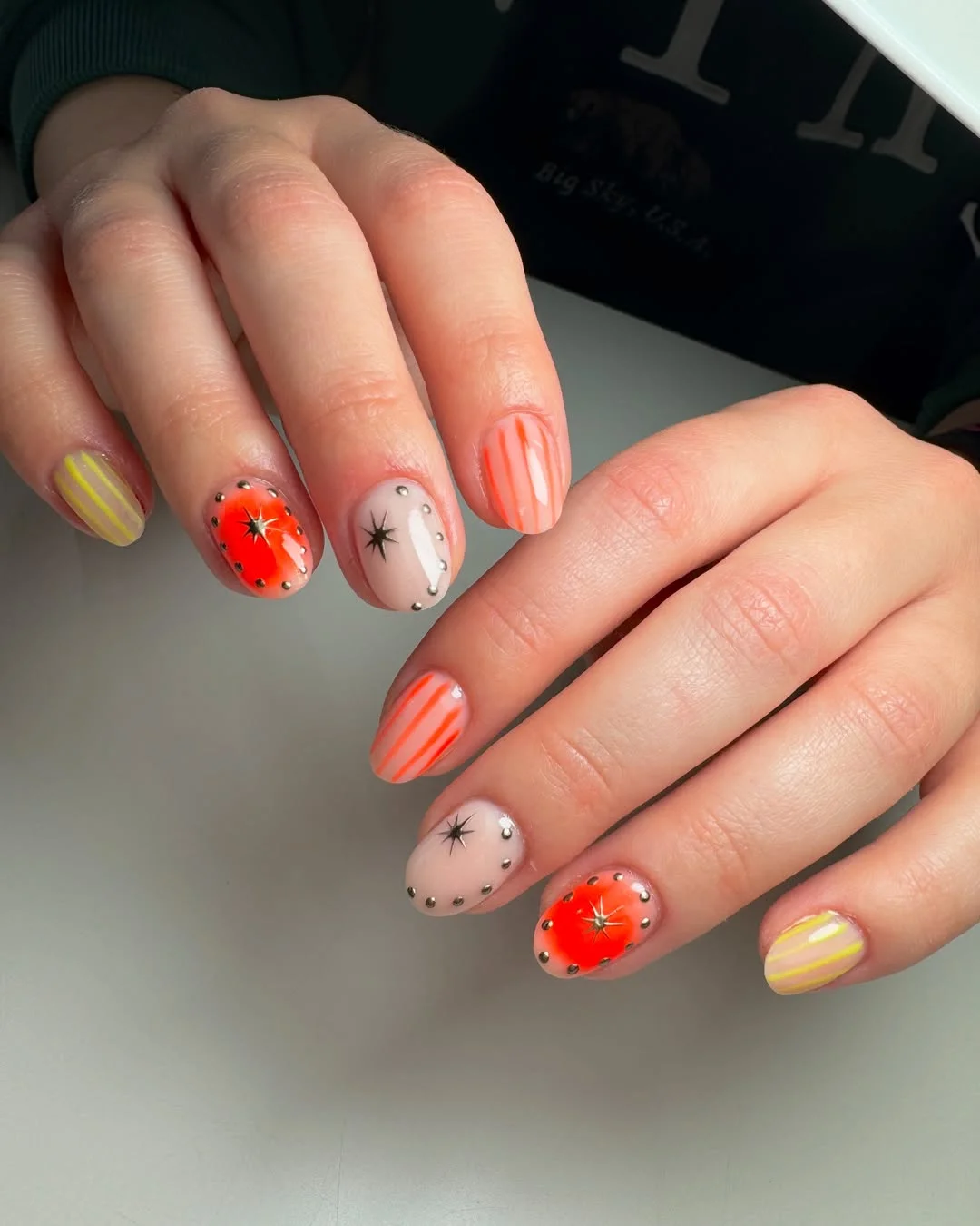 summer vibrant nails summer 2026 Short Orange Nails With Tiny Studs and Star Accents