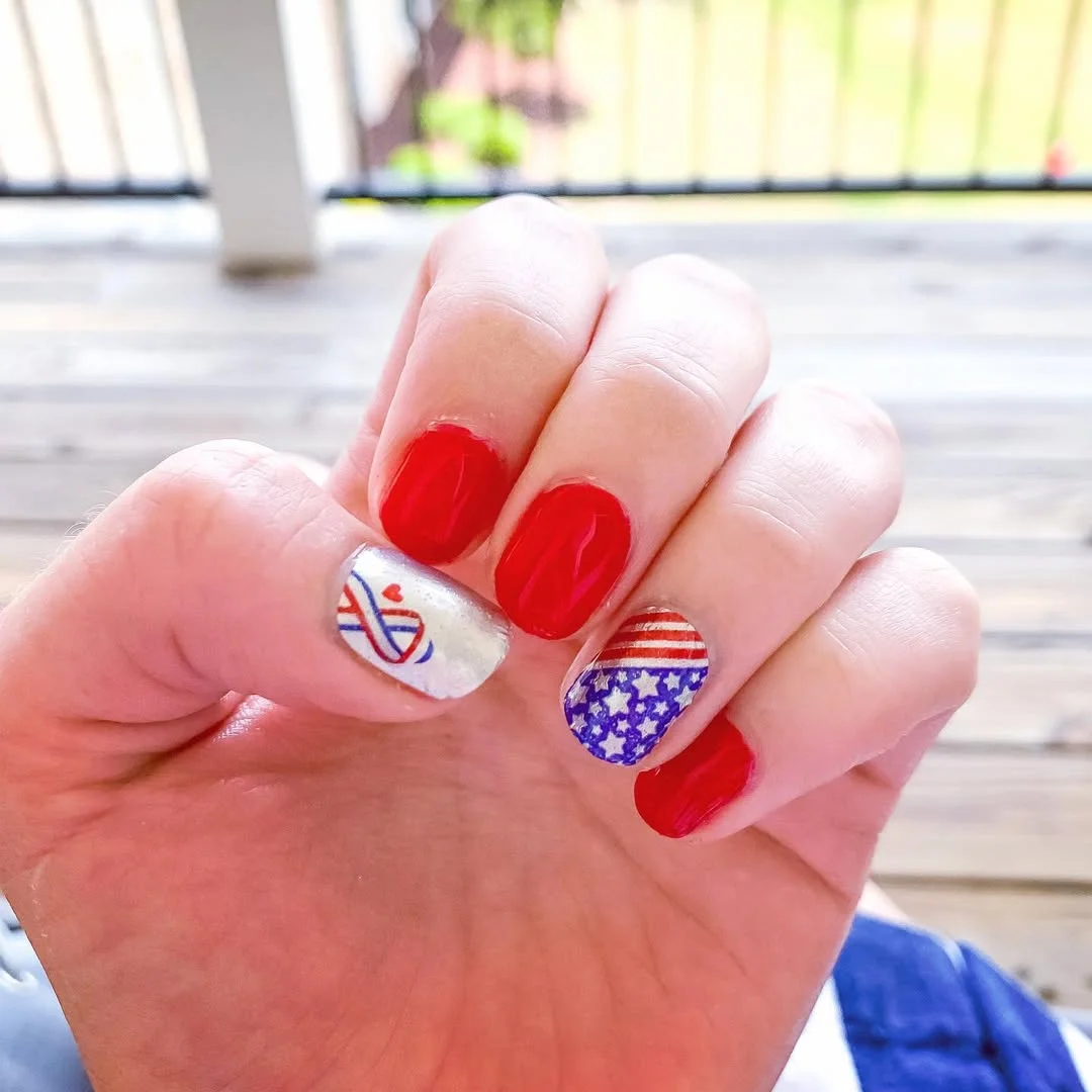 usa nails 2026 Classic Red Nails With A Flag Accent And Tiny Heart Detail