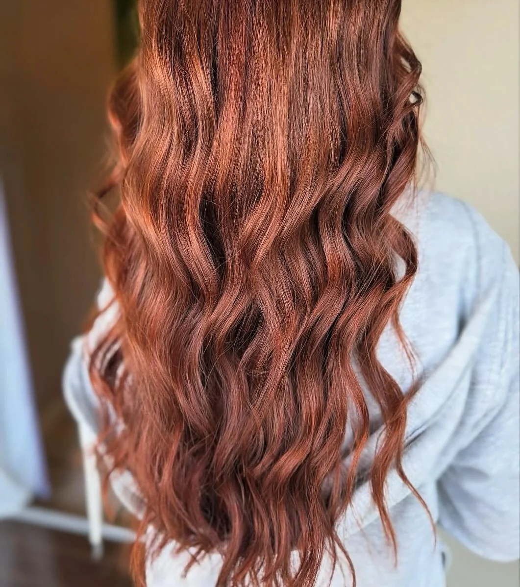warm summer auburn hair color 2026 Rosy Auburn Waves With Soft Dimension