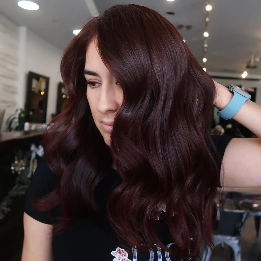 warm summer auburn hair color 2026 Deep Blackberry Auburn With Soft Waves