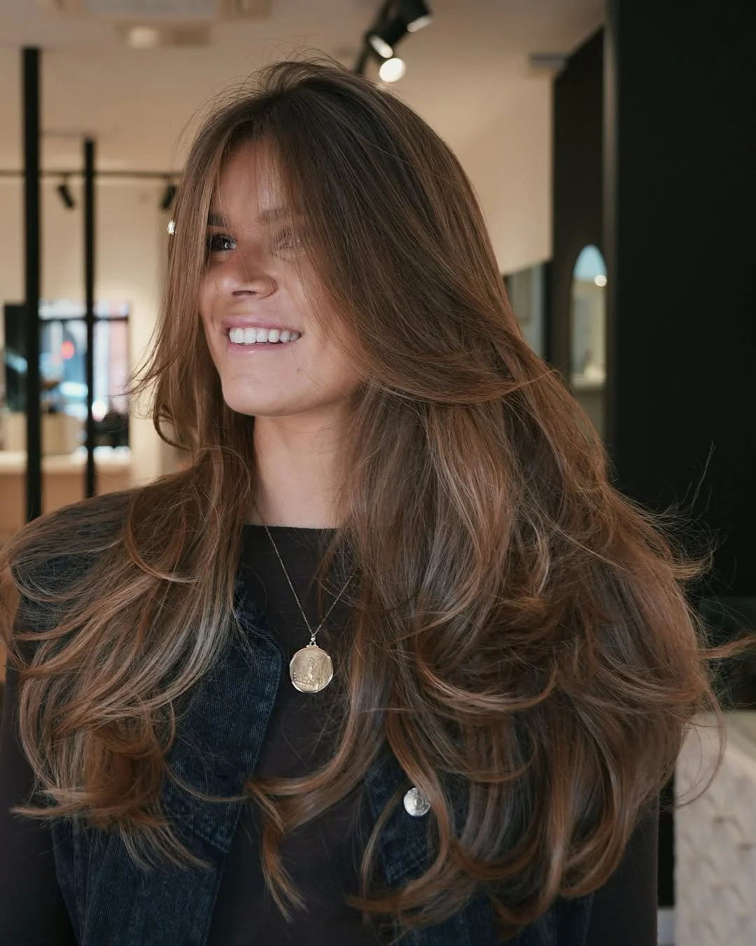 warm summer brunette hair color 2026 Layered Brunette With Sunlit Caramel Movement