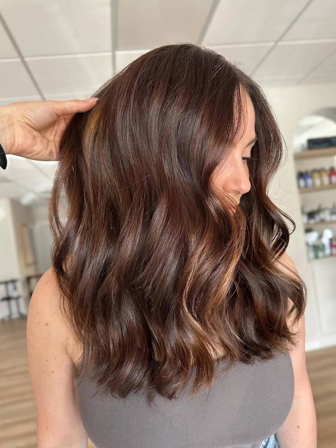 warm summer brunette hair color 2026 Soft Mocha Brunette With Shoulder-Length Waves