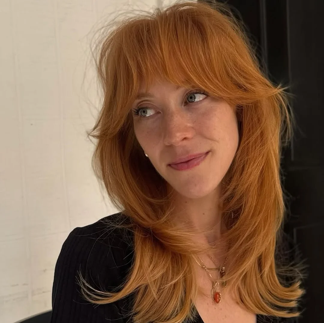youthful summer haircuts for women over 40 2026 Copper Butterfly Layers With Wispy Summer Bangs