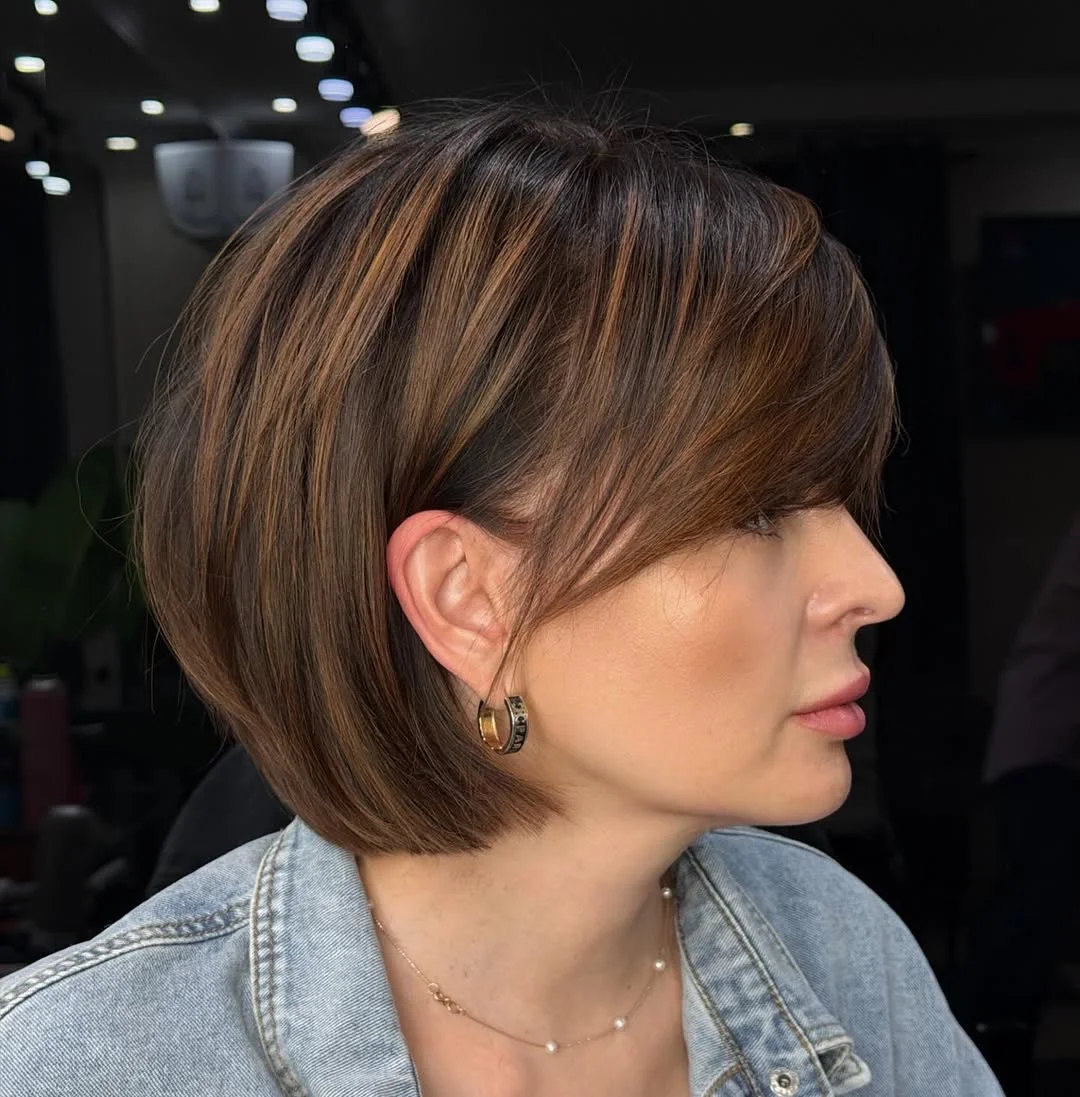 youthful summer haircuts for women over 40 2026 Rounded Brunette Bob With Side-Swept Fringe