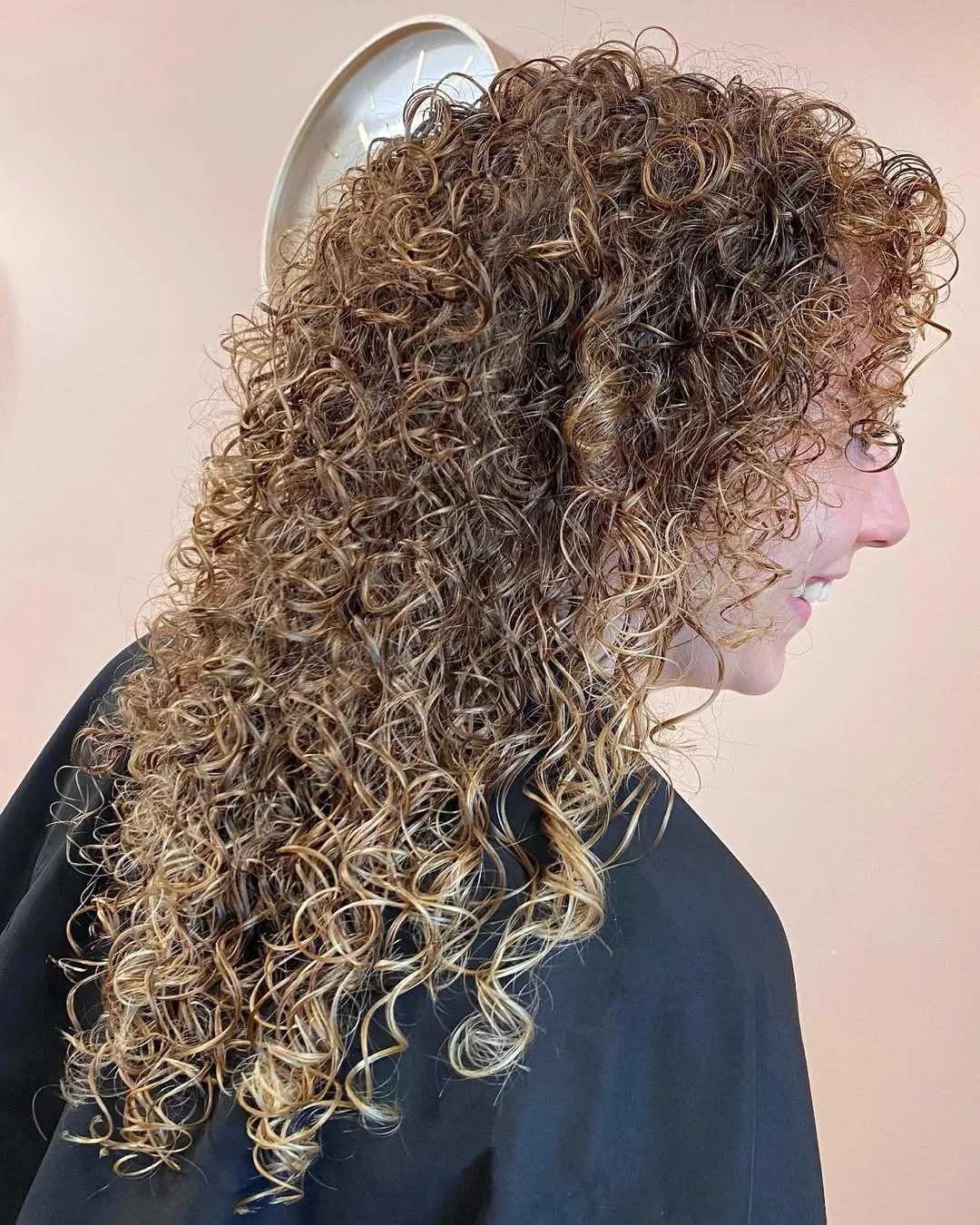 youthful summer haircuts for women over 40 2026 Curly Shoulder-Length Layers With Sunlit Dimension