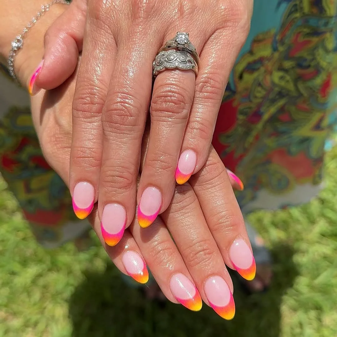 bright summer nails 2026 Sunset Neon French Tips On A Milky Pink Base