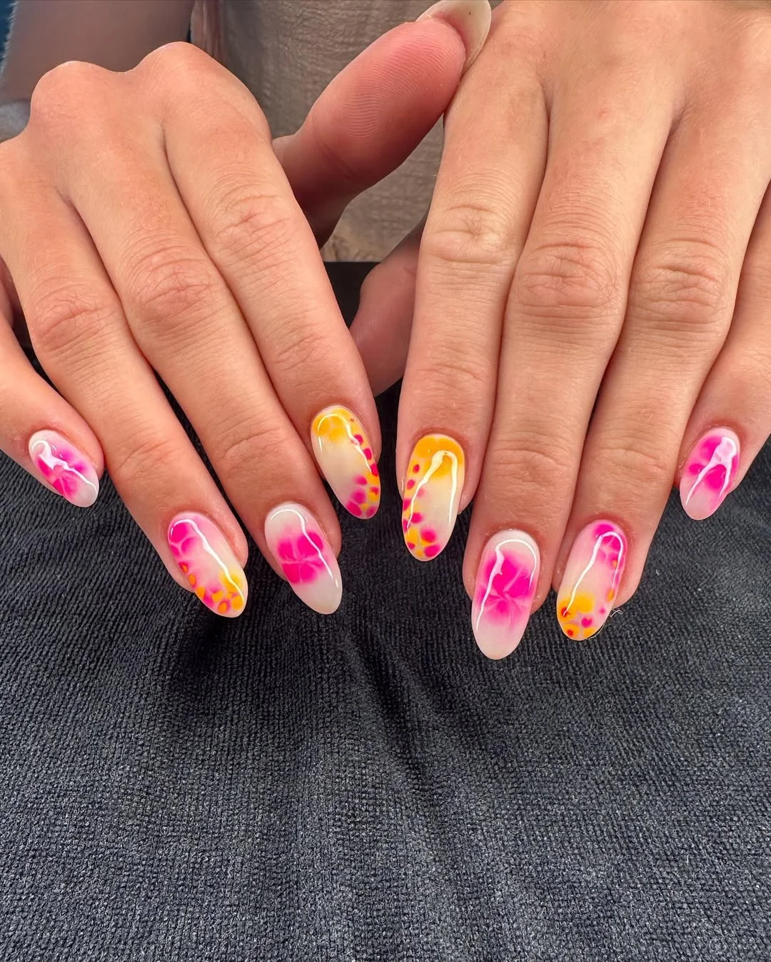 bright summer nails 2026 Neon Pink And Orange Aura Florals On Almond Nails