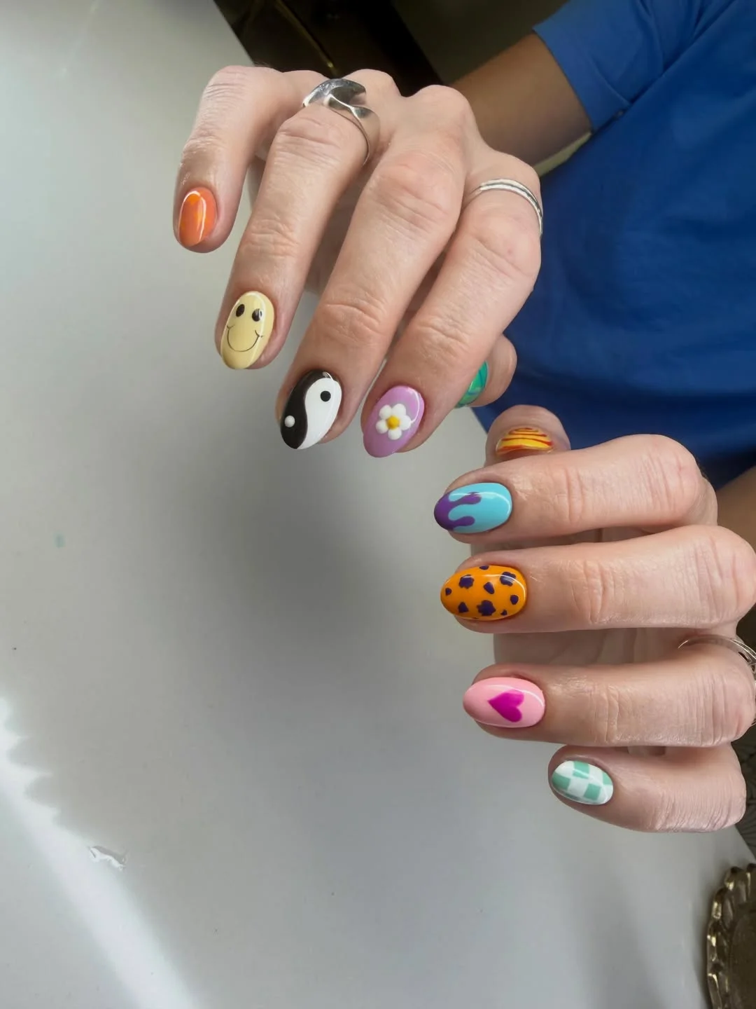 funky summer nails 2026 Short Mixed Pop Nails With Smiley Faces And Graphic Prints
