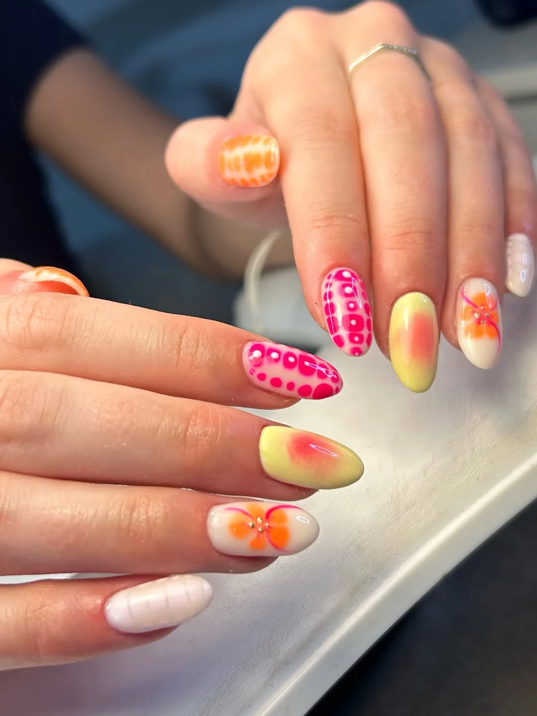 funky summer nails 2026 Soft Citrus Almond Nails With Pink Dots And Orange Flowers