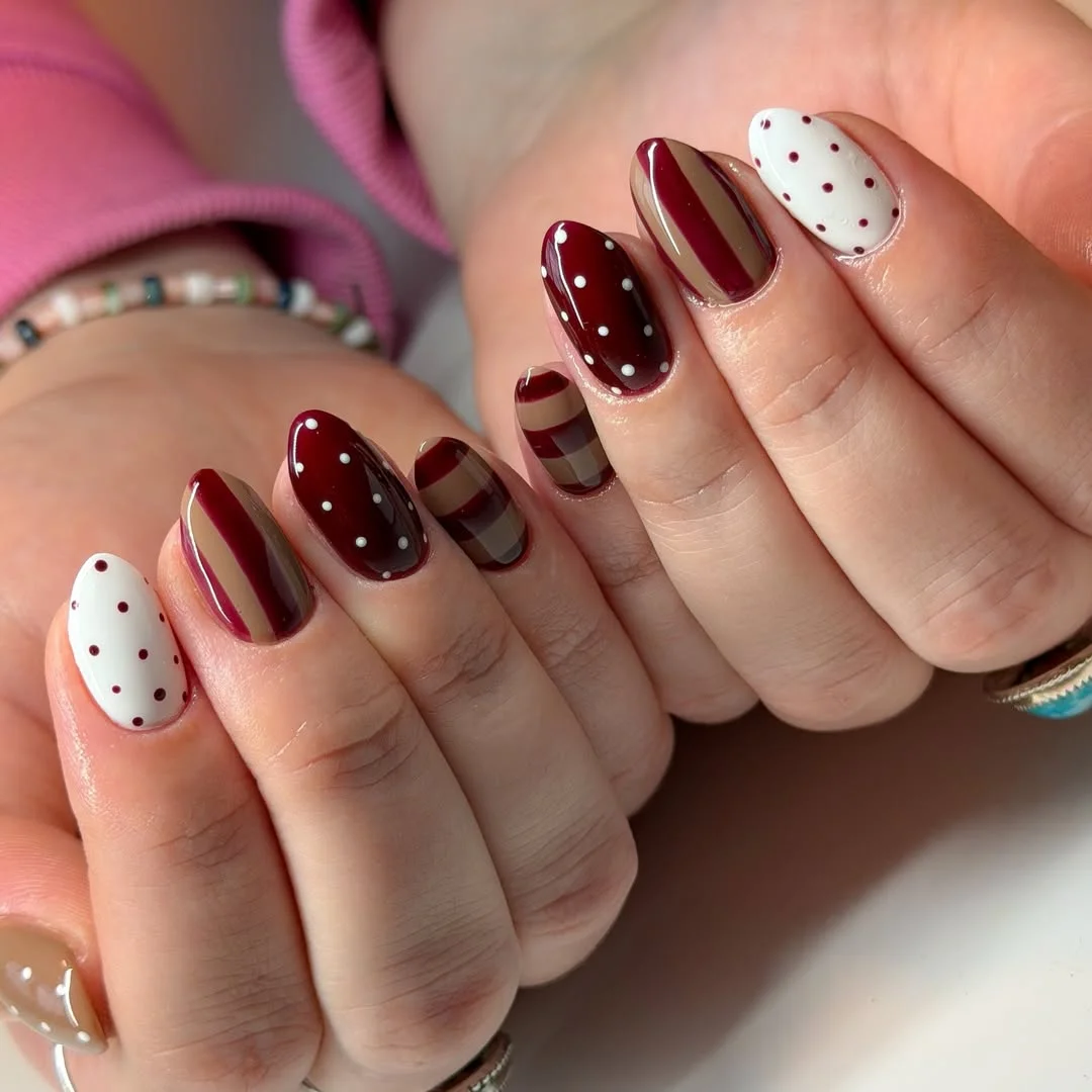 july nail colours ideas 2026 Burgundy And Cream Polka Dot Nails With Retro Stripes