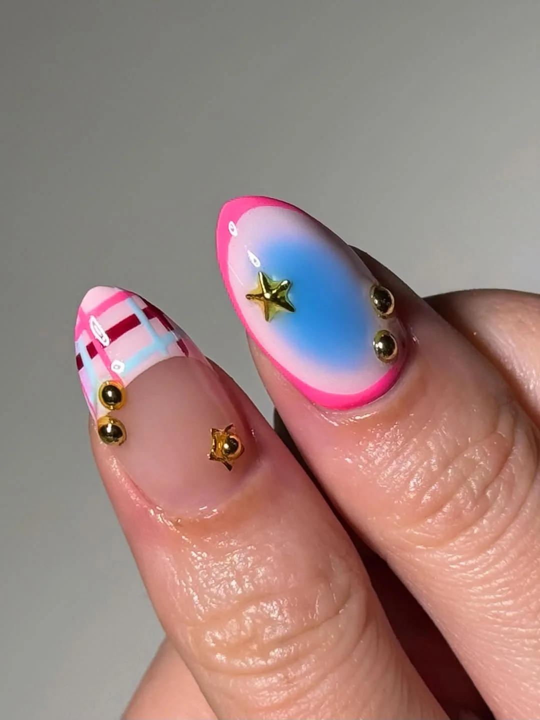 july nails design ideas 2026 Pink And Blue Mini Nail Art With Gold Charms