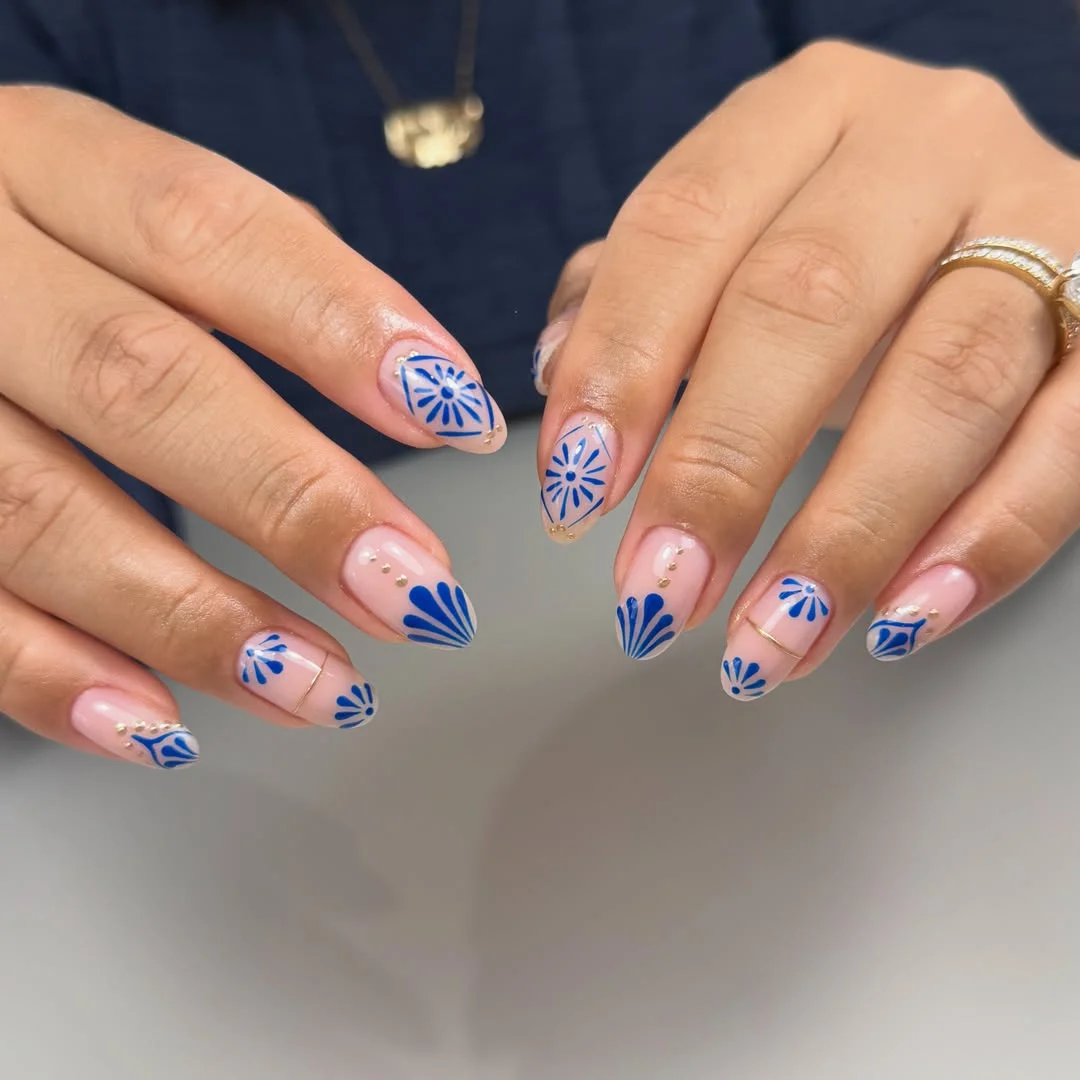 july nails design ideas 2026 Blue Starburst Nails With Delicate Gold Details