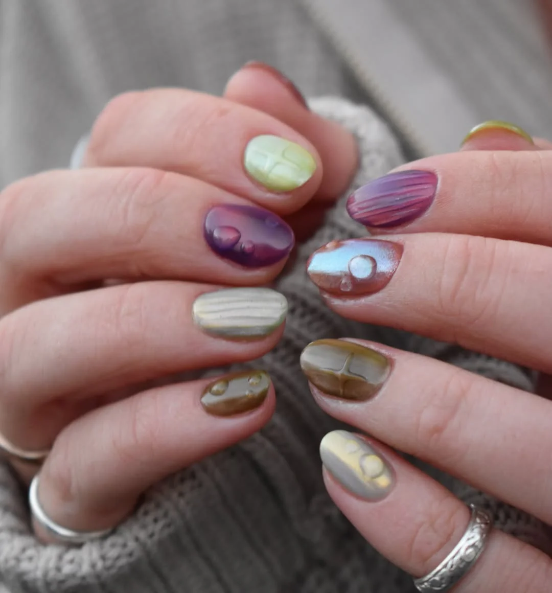 july nails design ideas 2026 Earthy Chrome Pebble Nails With Sculpted Texture