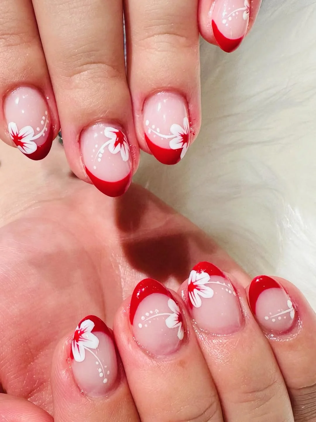 july nails design ideas 2026 Red French Tips With White Floral Details