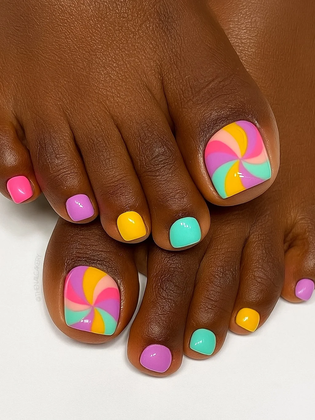 july toe nail colours ideas 2026 Candy Swirl Pedicure in Bright Summer Colors