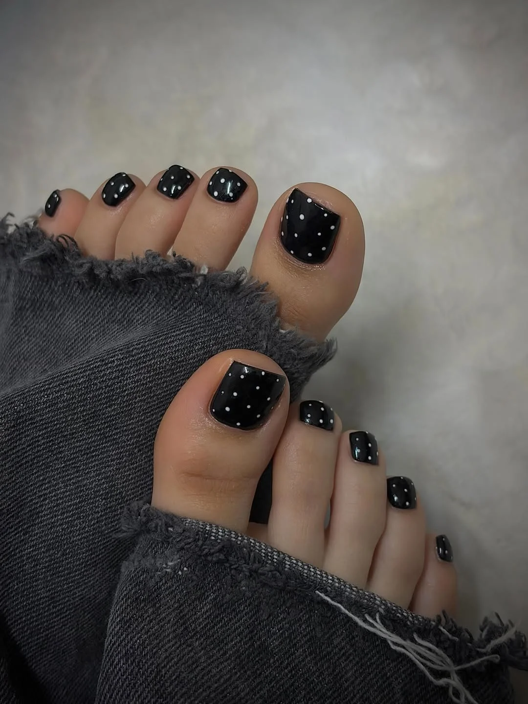 july toe nail colours ideas 2026 Black Polka Dot Pedicure with a Chic Minimal Edge