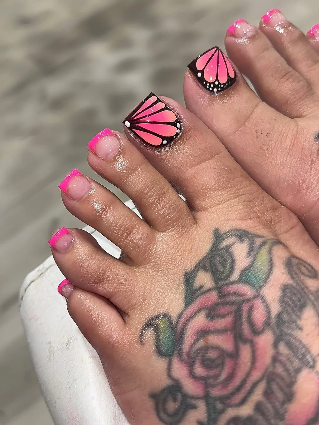 july toe nail colours ideas 2026 Hot Pink Butterfly Pedicure with a Neon French Accent