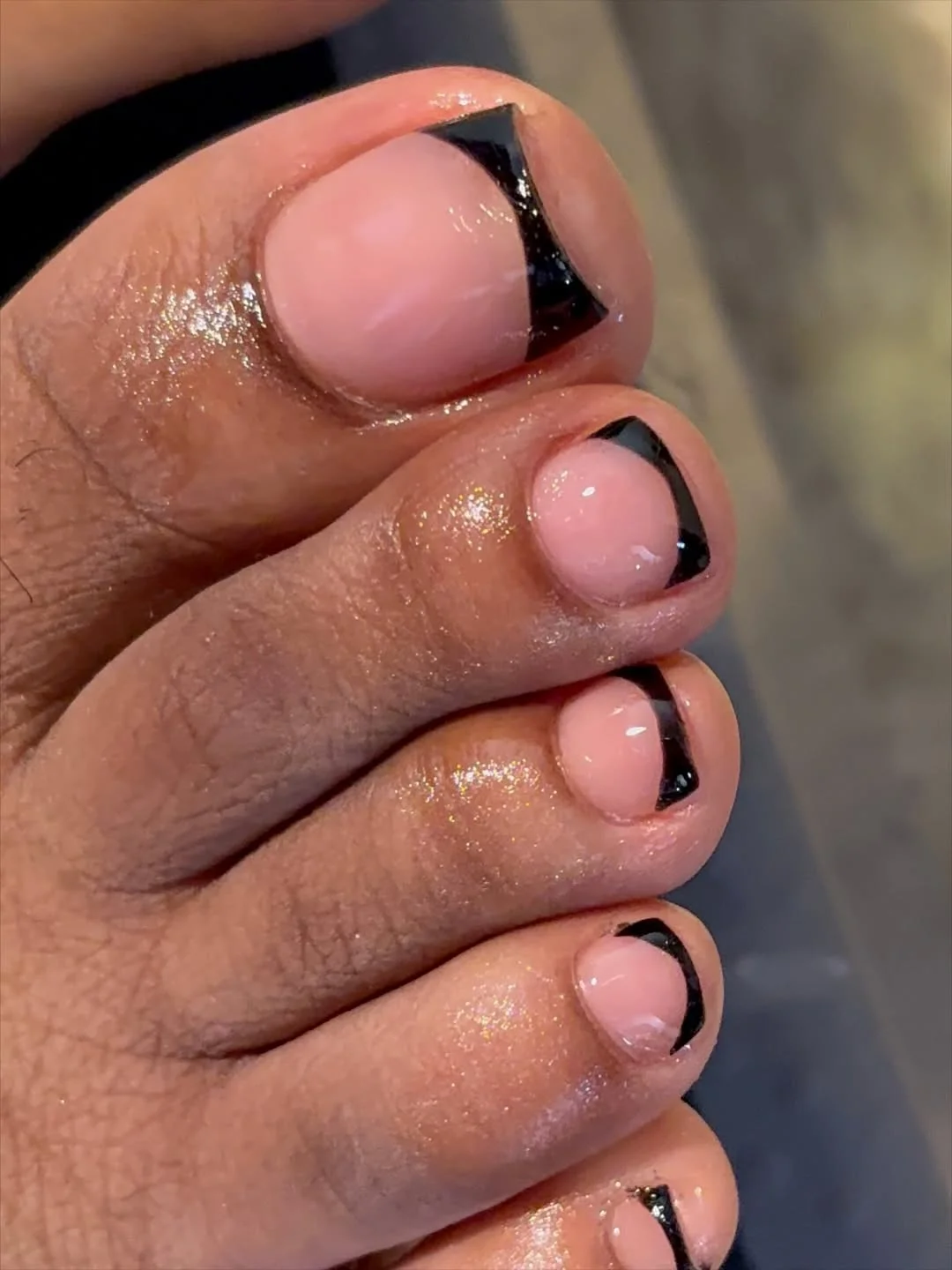 july toe nail colours ideas 2026 Black French Tips with a Glossy Nude Base