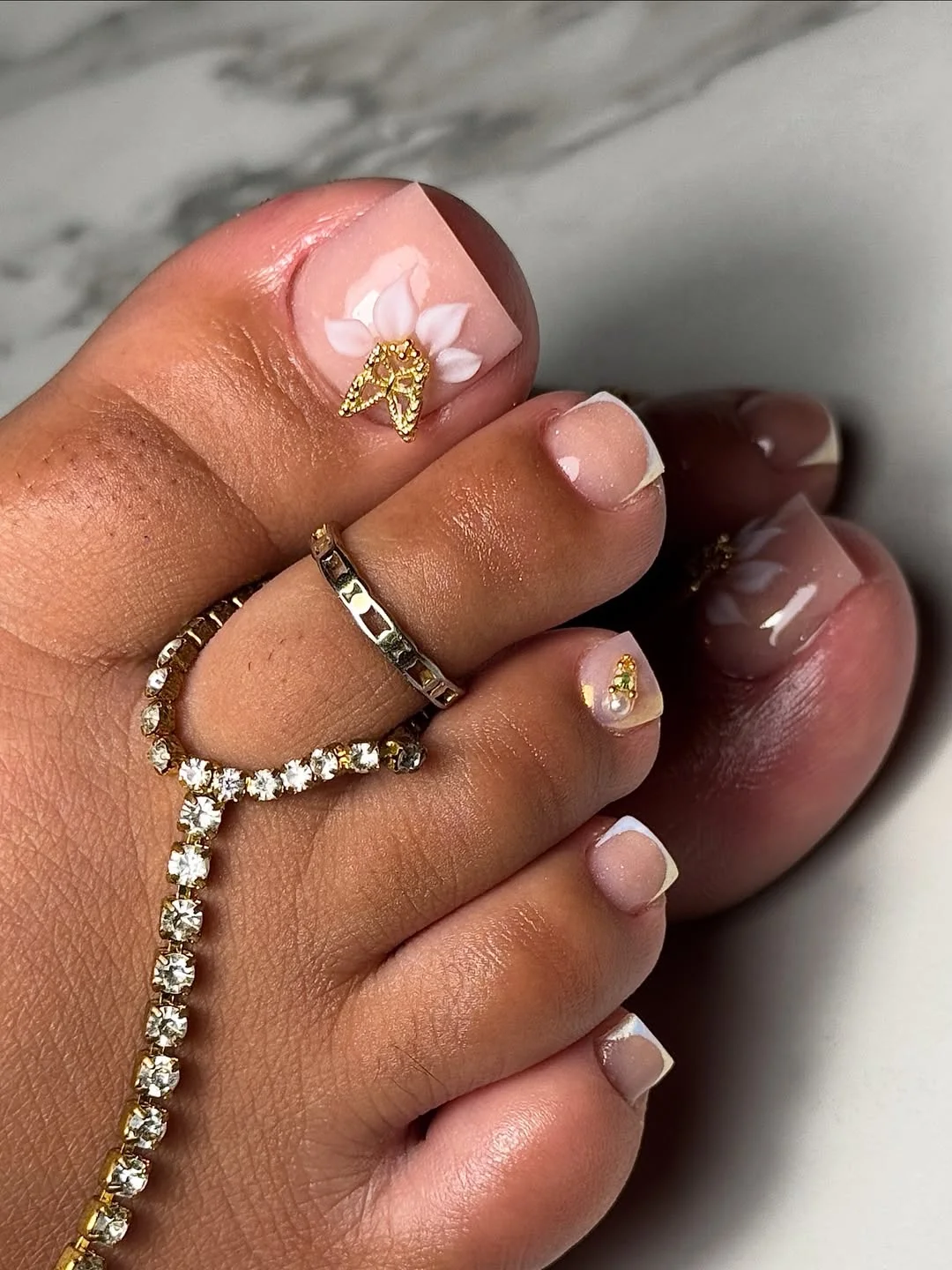 july toe nails design - summer ideas 2026 Soft French Flower Toes With Tiny Gold Detail