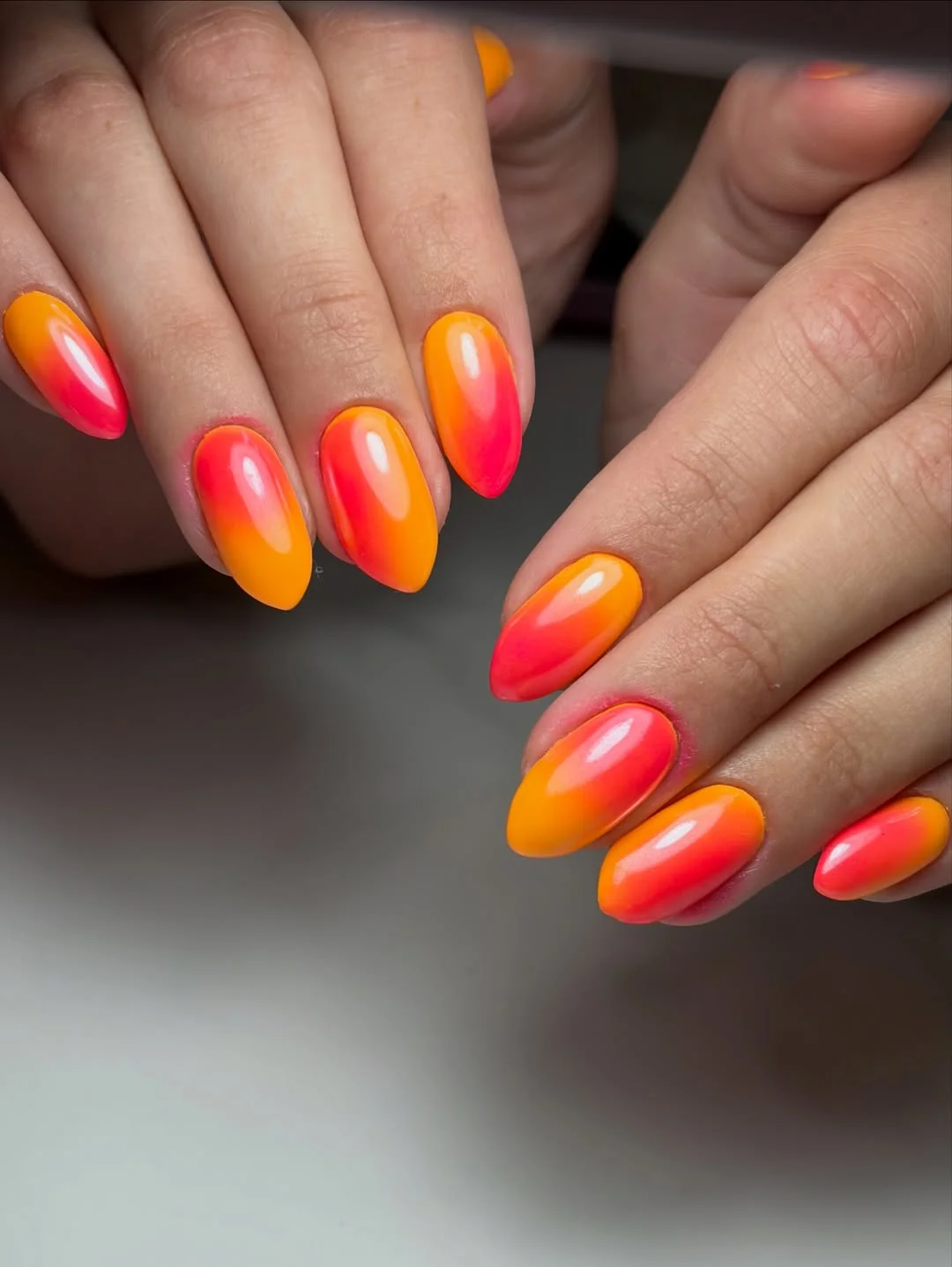 light summer nails 2026 Orange And Pink Glow Nails With A Juicy Summer Finish
