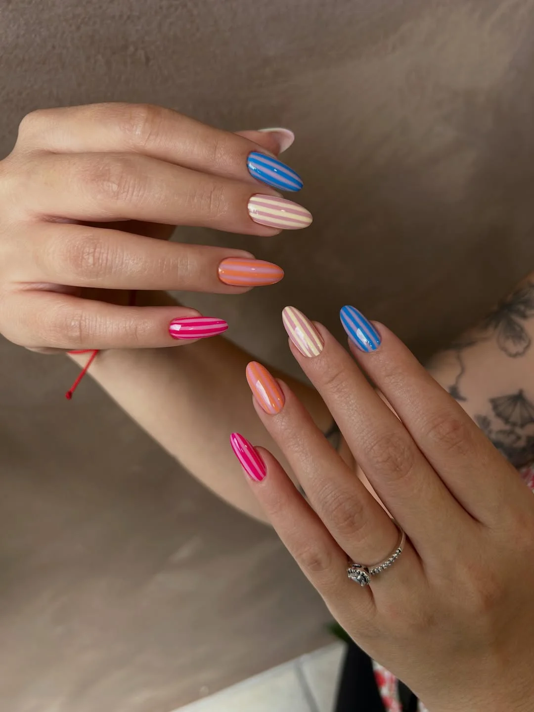 light summer nails 2026 Candy Stripe Almond Nails In Bright Summer Colors