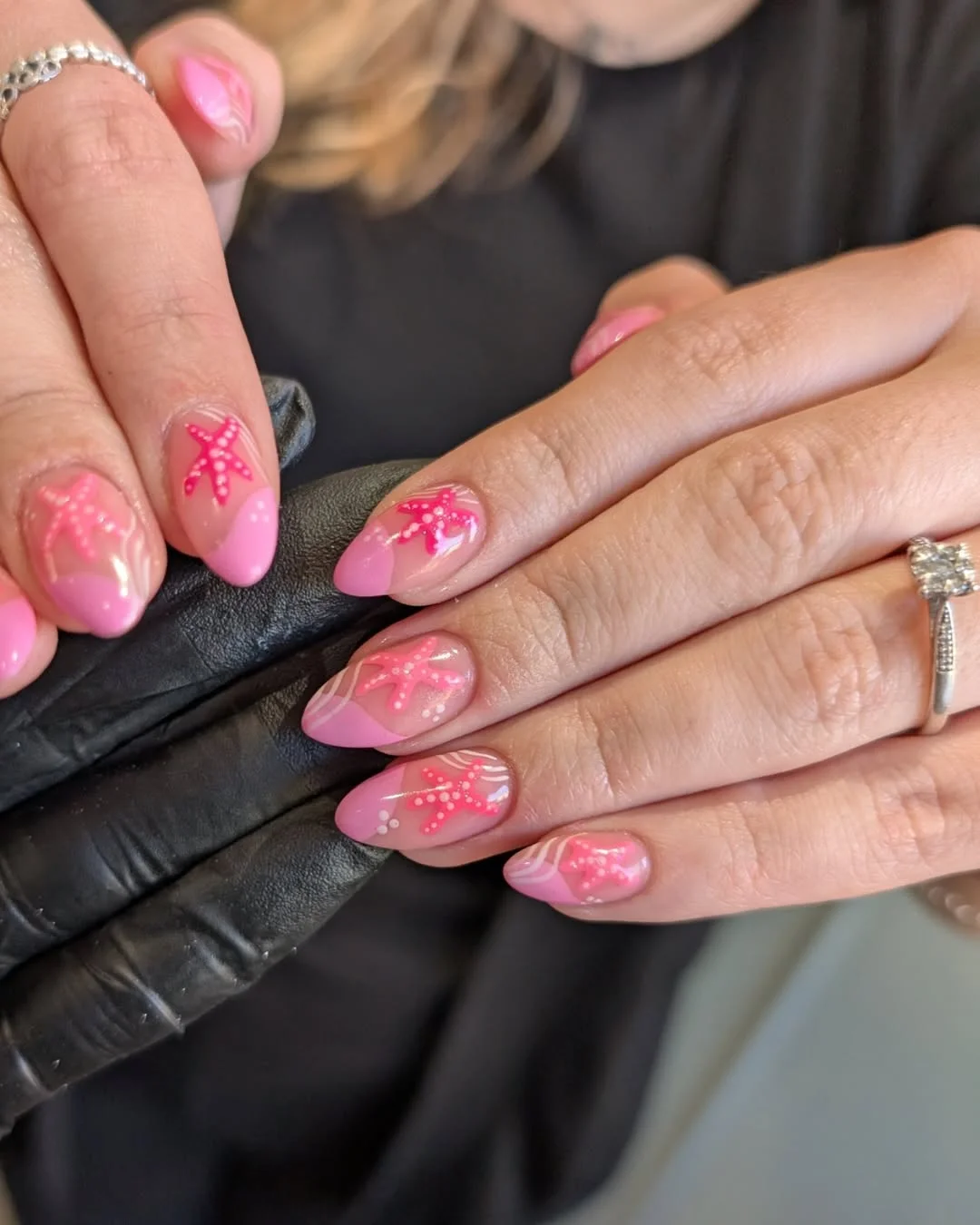 starfish summer nails 2026 Glossy Pink Almond Nails With Playful Starfish Swirls