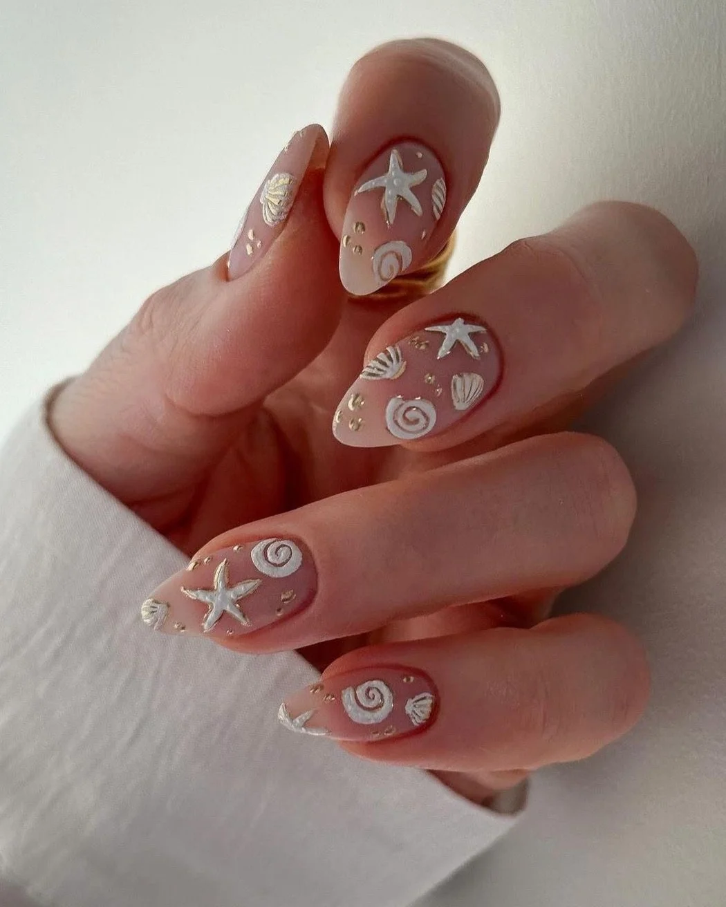 starfish summer nails 2026 Pearly Seashell Almond Nails With Gold Accents