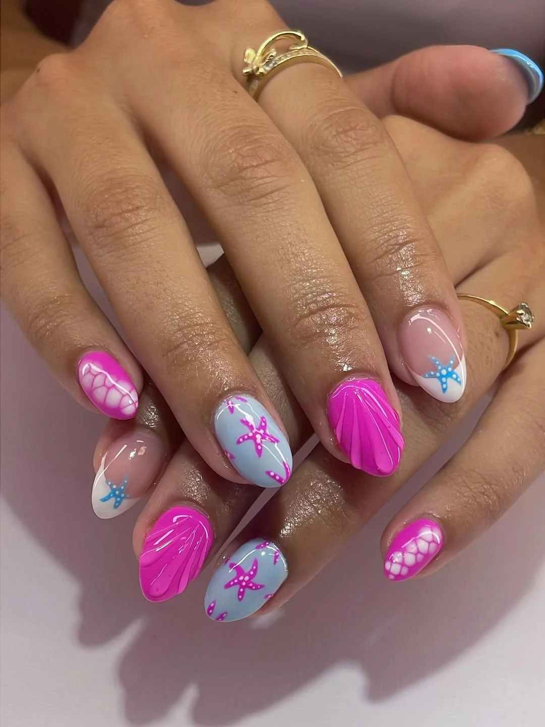 starfish summer nails 2026 Hot Pink Shell Nails With Blue Starfish Accents