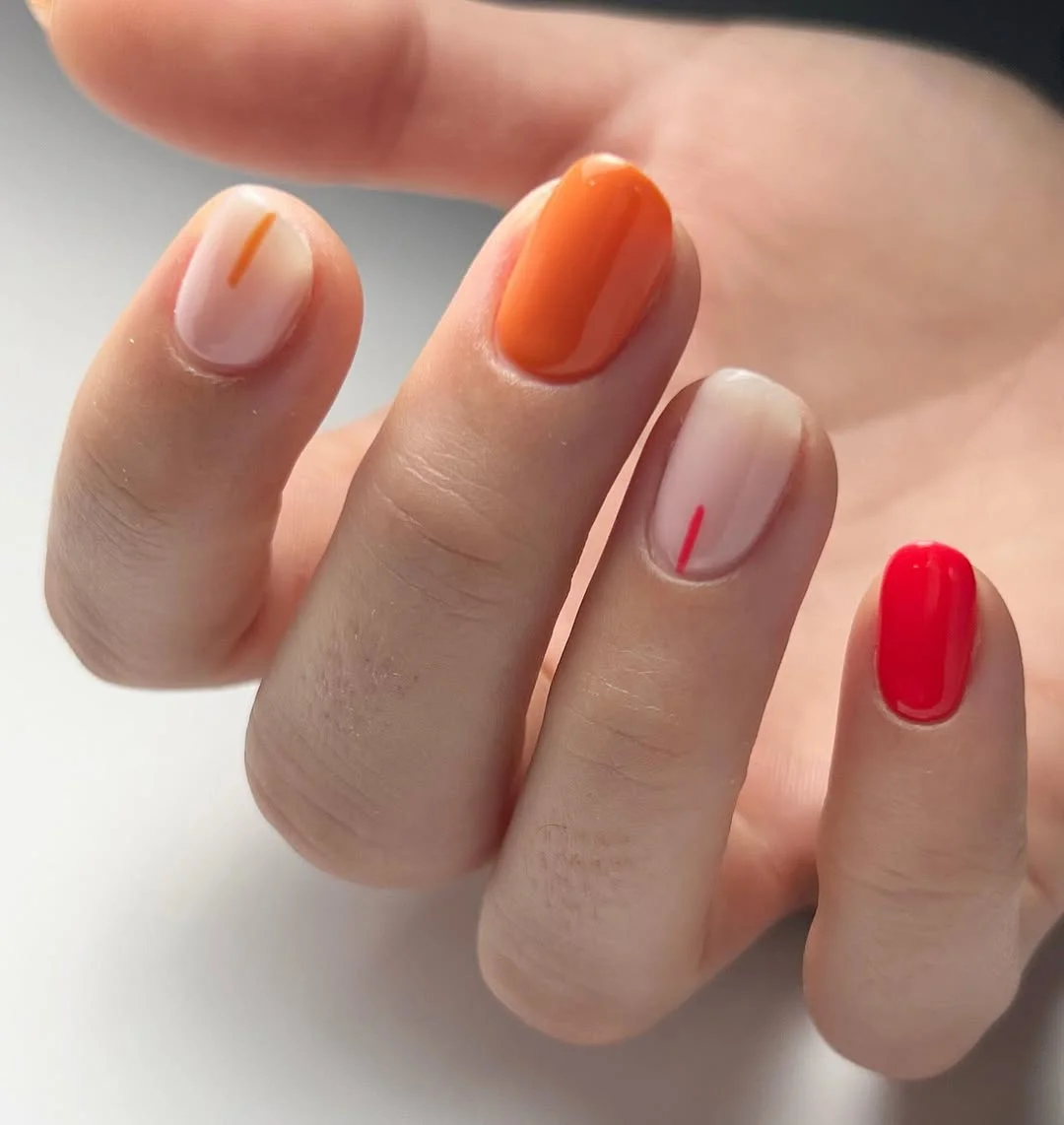 summer oval nails 2026 Orange And Red Short Oval Nails With Minimal Line Accents