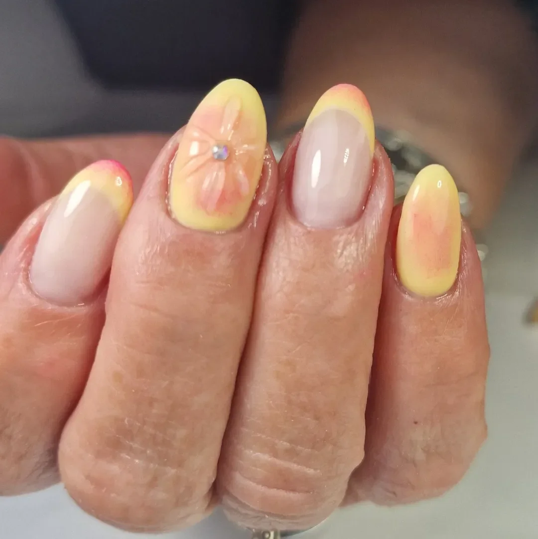 summer oval nails 2026 Yellow Ombre Oval Nails With A Soft Flower Accent